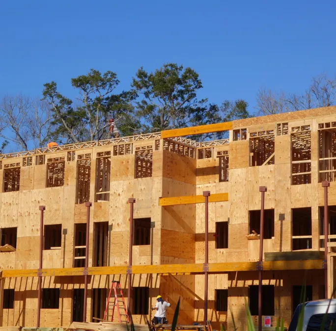 Large-scale commercial structural wood framing project by Framing Pro Dallas featuring multi-story building framing, exterior sheathing, and commercial construction progress in Dallas, Texas.