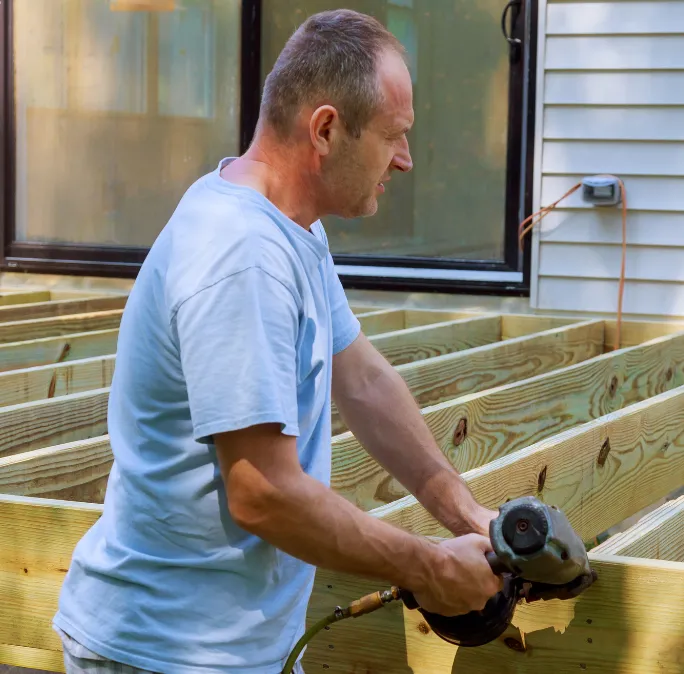 Residential deck joist framing installation by Framing Pro Dallas showing treated lumber deck framing, structural support beams, and outdoor living construction at a Dallas home.