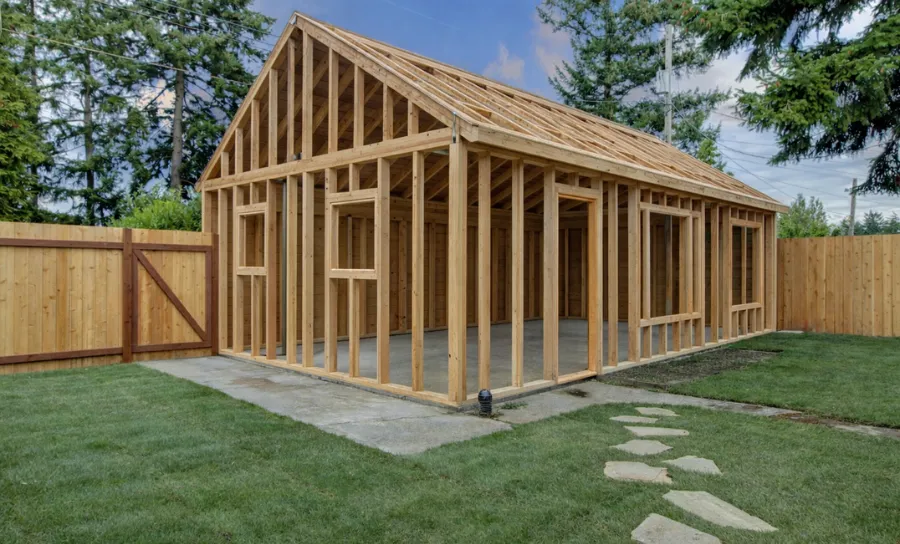 Accessory dwelling unit framing in a backyard showing full wood skeleton structure before exterior installation