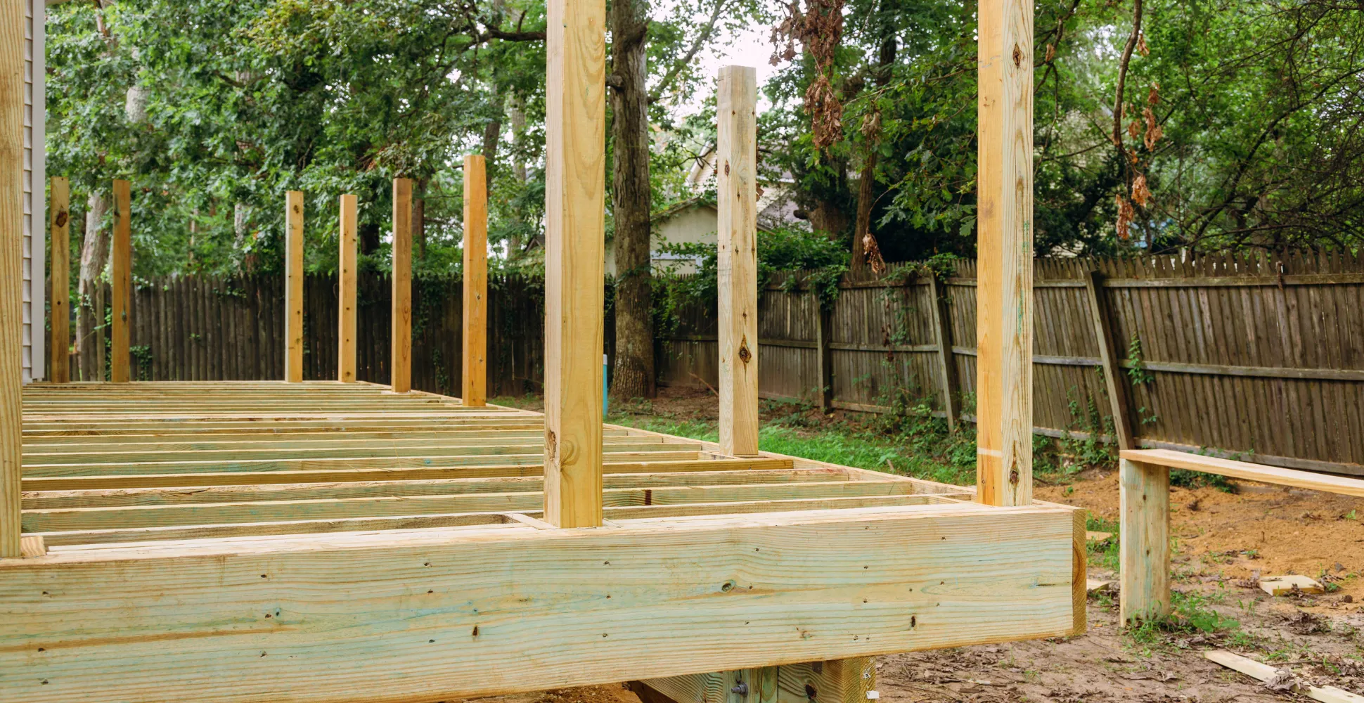 Deck framing structure in Dallas Texas using pressure-treated posts, beams, and footings for an outdoor living space