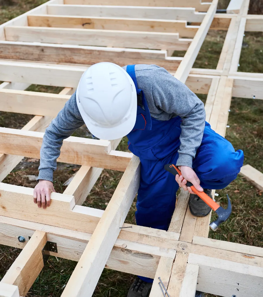 Deck and porch framing contractor working on an outdoor structure in Dallas Texas