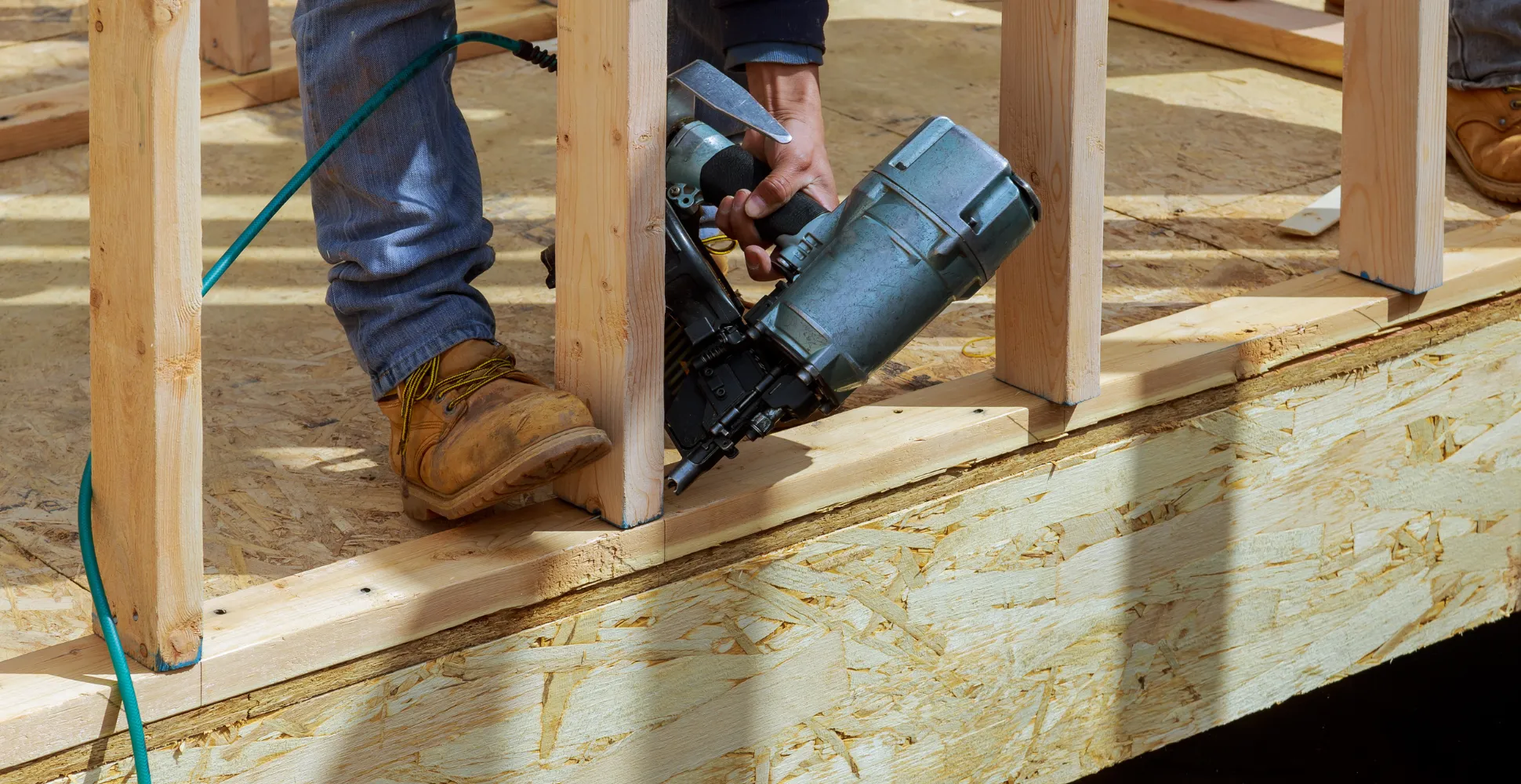 Residential framing contractor installing floor joists and wall studs for new home construction in Dallas TX